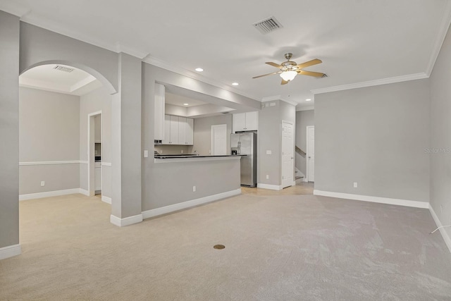 16137 Churchview Dr, Lithia, FL 33547 - unfurnished living room featuring light carpet, a ceiling fan, arched walkways, baseboards, and recessed lighting