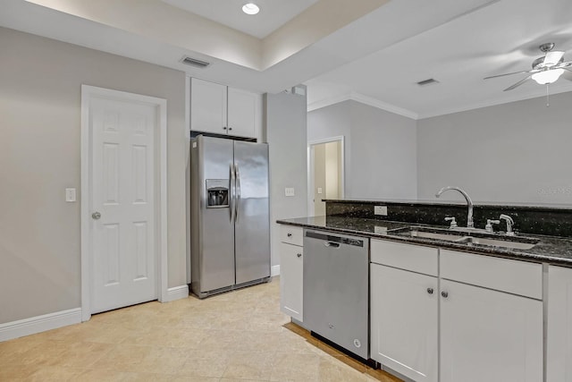 16137 Churchview Dr, Lithia, FL 33547 - kitchen featuring appliances with stainless steel finishes, a sink, a ceiling fan, white cabinets, and dark stone counters