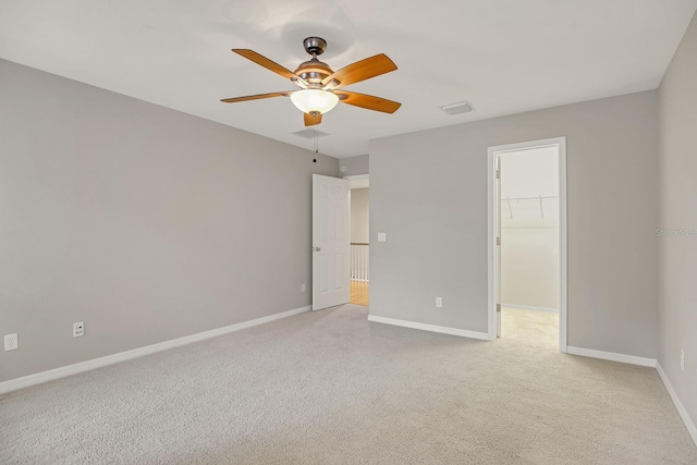 16137 Churchview Dr, Lithia, FL 33547 - unfurnished bedroom featuring baseboards, light carpet, a walk in closet, and a ceiling fan