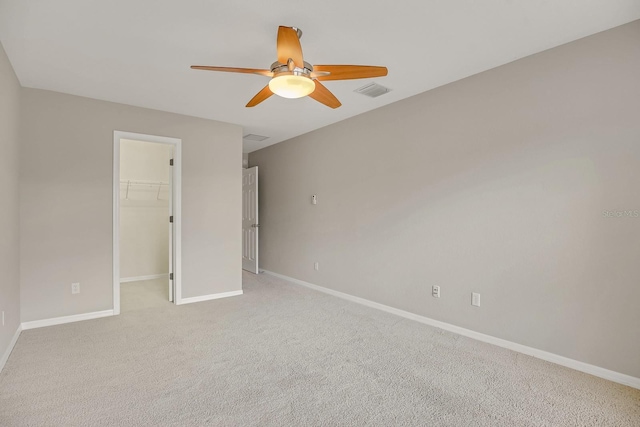 16137 Churchview Dr, Lithia, FL 33547 - unfurnished bedroom with baseboards, a spacious closet, light colored carpet, a closet, and a ceiling fan