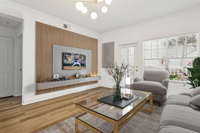 800 S Dakota Ave Unit 204, Tampa, FL 33606 - living area featuring wood finished floors, healthy amount of natural light, a chandelier, crown molding, and baseboards