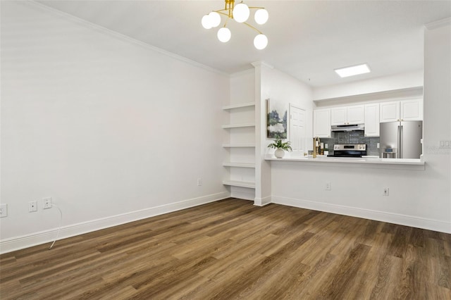 800 S Dakota Ave Unit 204, Tampa, FL 33606 - kitchen with appliances with stainless steel finishes, under cabinet range hood, dark wood finished floors, ornamental molding, and a chandelier