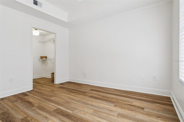 800 S Dakota Ave Unit 204, Tampa, FL 33606 - empty room with wood finished floors, ornamental molding, and baseboards