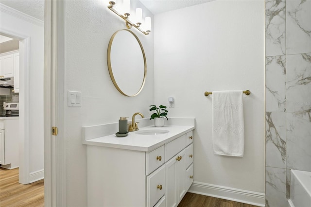 800 S Dakota Ave Unit 204, Tampa, FL 33606 - full bath with vanity, wood finished floors, crown molding, and baseboards