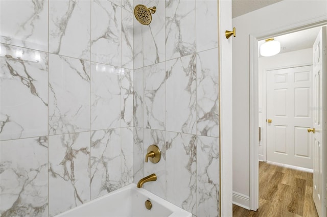800 S Dakota Ave Unit 204, Tampa, FL 33606 - bathroom with wood finished floors and tub / shower combination