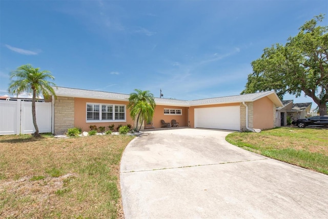 9591 Commodore Dr, Seminole, FL 33776 - single story home with driveway, an attached garage, and stucco siding