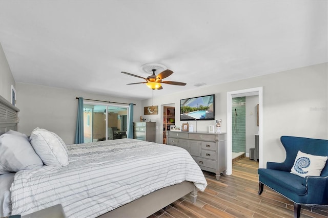 9591 Commodore Dr, Seminole, FL 33776 - bedroom with wood finished floors, baseboards, ceiling fan, ensuite bathroom, and access to exterior
