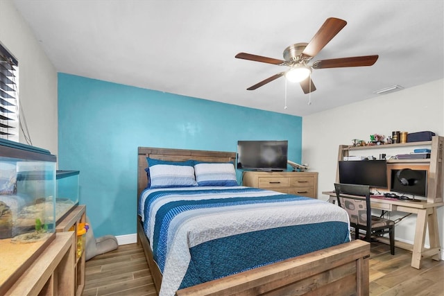 9591 Commodore Dr, Seminole, FL 33776 - bedroom featuring wood finished floors, baseboards, and ceiling fan