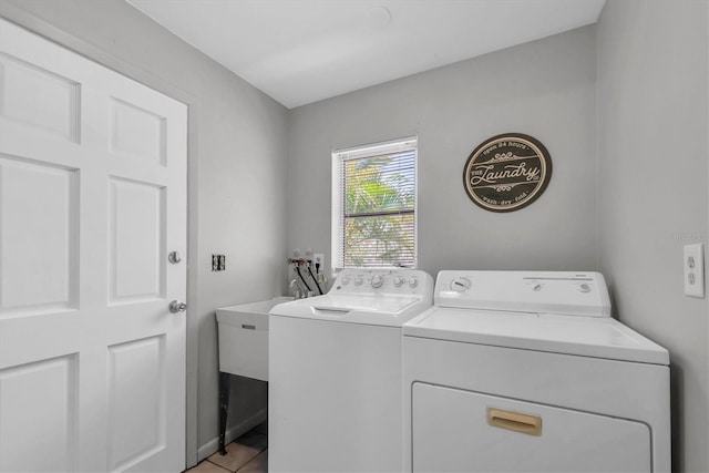 9591 Commodore Dr, Seminole, FL 33776 - laundry area featuring washer and clothes dryer and light tile patterned flooring