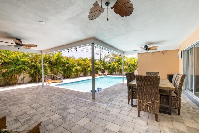 9591 Commodore Dr, Seminole, FL 33776 - outdoor pool with ceiling fan, a patio area, and outdoor dining area