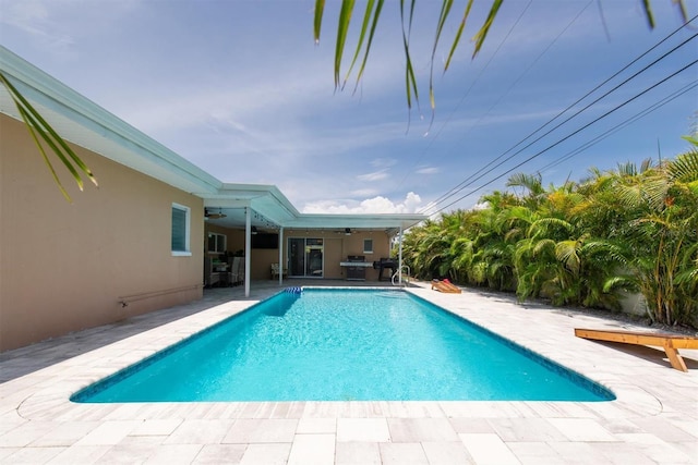9591 Commodore Dr, Seminole, FL 33776 - swimming pool with a ceiling fan, a patio, and area for grilling