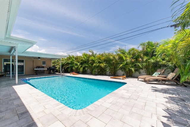 9591 Commodore Dr, Seminole, FL 33776 - view of swimming pool with a patio, ceiling fan, and grilling area