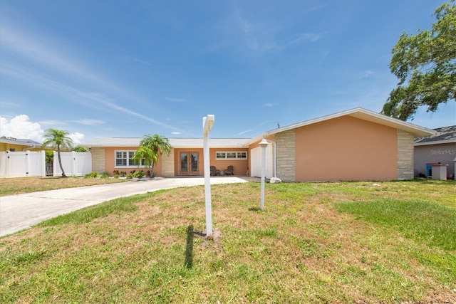 9591 Commodore Dr, Seminole, FL 33776 - ranch-style house with driveway, french doors, stucco siding, and an attached garage