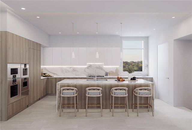 1028 Sunset Point Rd Unit R4, Clearwater, FL 33755 - kitchen with modern cabinets, a breakfast bar, a large island, decorative backsplash, and recessed lighting