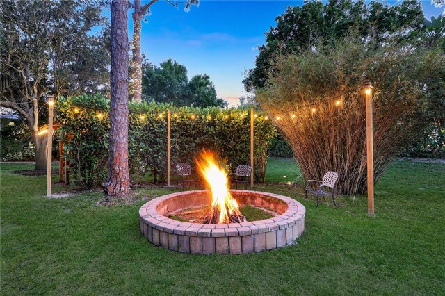 1817 Piccadilly Cir, Cape Coral, FL 33991 - view of green lawn featuring an outdoor fire pit