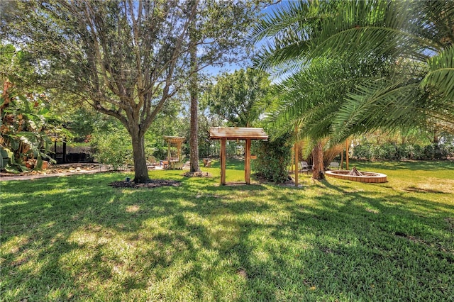 1817 Piccadilly Cir, Cape Coral, FL 33991 - view of green lawn with a fire pit