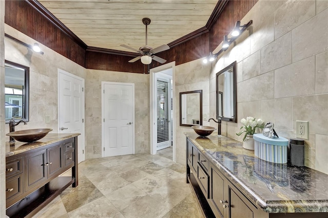 1817 Piccadilly Cir, Cape Coral, FL 33991 - full bath featuring tile walls, two vanities, wood ceiling, ceiling fan, and ornamental molding