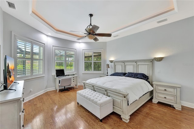1817 Piccadilly Cir, Cape Coral, FL 33991 - bedroom with a raised ceiling, light wood-type flooring, baseboards, a ceiling fan, and a desk