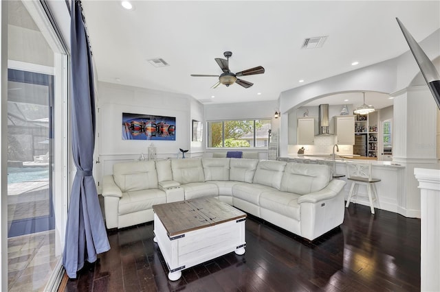 1817 Piccadilly Cir, Cape Coral, FL 33991 - living room with a ceiling fan, dark wood-type flooring, a decorative wall, and recessed lighting
