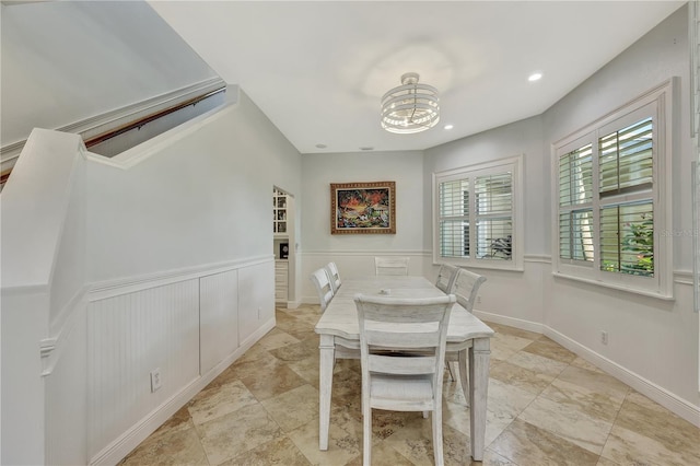 1817 Piccadilly Cir, Cape Coral, FL 33991 - dining area with a chandelier, wainscoting, recessed lighting, and a decorative wall