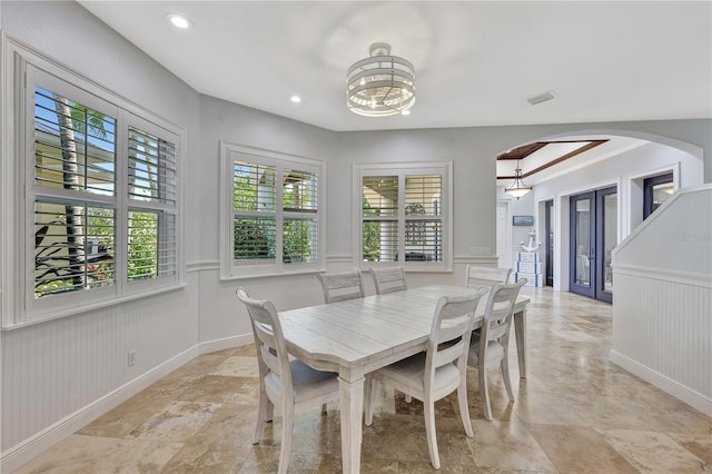 1817 Piccadilly Cir, Cape Coral, FL 33991 - dining area with arched walkways, a chandelier, a wainscoted wall, recessed lighting, and a decorative wall