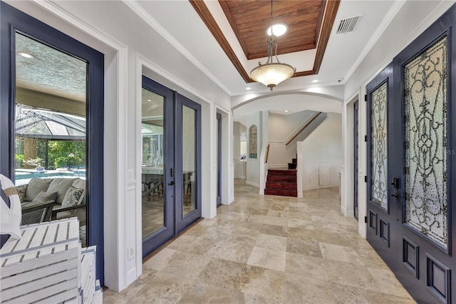 1817 Piccadilly Cir, Cape Coral, FL 33991 - foyer entrance with french doors, a tray ceiling, arched walkways, a decorative wall, and stairs