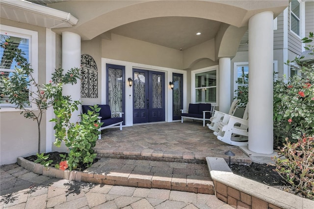1817 Piccadilly Cir, Cape Coral, FL 33991 - doorway to property with french doors, stucco siding, and a porch
