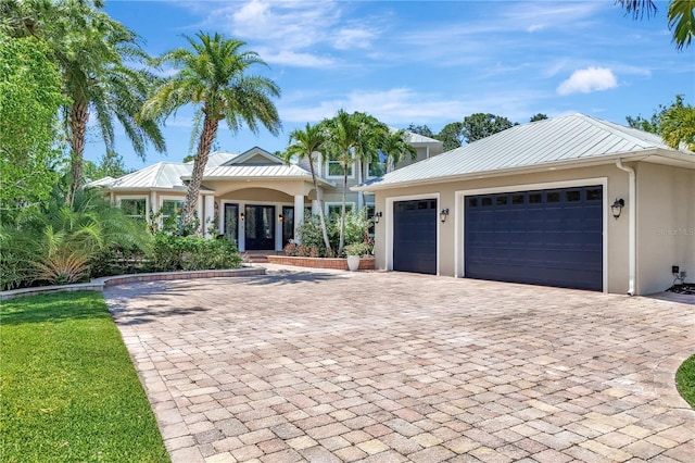 1817 Piccadilly Cir, Cape Coral, FL 33991 - single story home with decorative driveway, stucco siding, french doors, a standing seam roof, and metal roof
