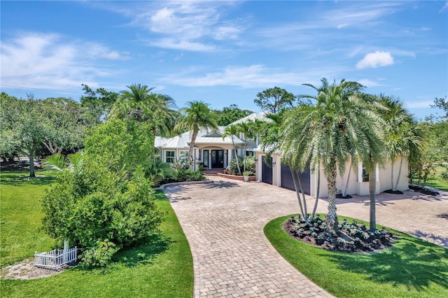 1817 Piccadilly Cir, Cape Coral, FL 33991 - view of front of home featuring decorative driveway, a garage, stucco siding, and a front yard
