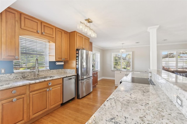 3966 High Bluff Dr, Largo, FL 33770 - kitchen with stainless steel appliances, a sink, light wood-style flooring, light stone counters, and plenty of natural light