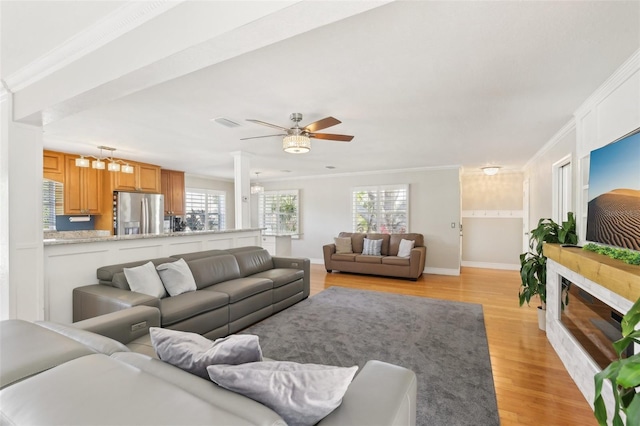3966 High Bluff Dr, Largo, FL 33770 - living room featuring ornamental molding, light wood-style floors, baseboards, and a ceiling fan