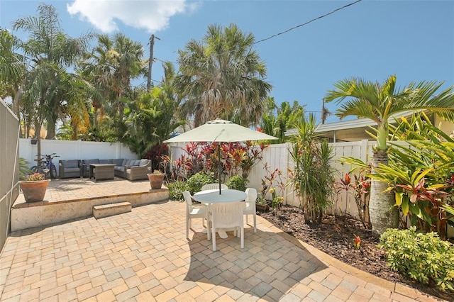 3966 High Bluff Dr, Largo, FL 33770 - fenced backyard featuring an outdoor hangout area, a patio, and outdoor dining area