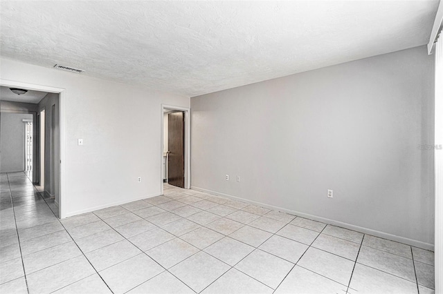 4309 Cedar Grove St, Holiday, FL 34691 - spare room featuring light tile patterned floors, baseboards, and a textured ceiling