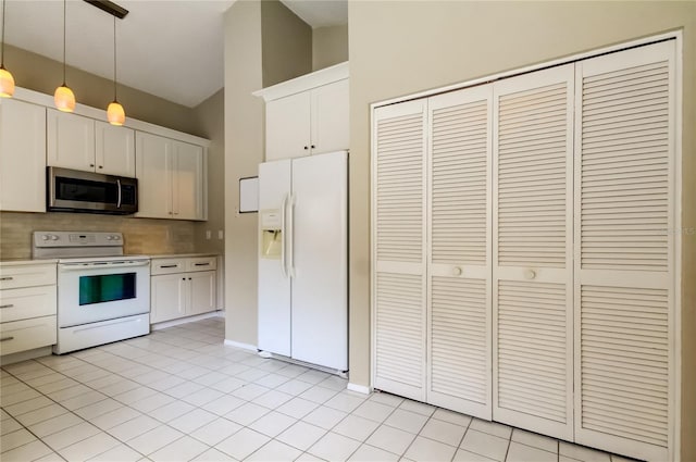11641 Branch Mooring Dr, Tampa, FL 33635 - kitchen with white appliances, backsplash, decorative light fixtures, light countertops, and white cabinetry