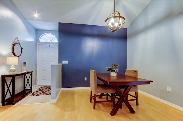 11641 Branch Mooring Dr, Tampa, FL 33635 - dining area featuring light wood finished floors, a chandelier, lofted ceiling, and baseboards