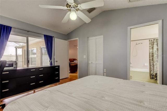 11641 Branch Mooring Dr, Tampa, FL 33635 - bedroom with lofted ceiling, wood finished floors, ensuite bath, a ceiling fan, and a closet