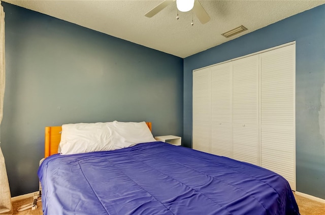 11641 Branch Mooring Dr, Tampa, FL 33635 - carpeted bedroom with baseboards, ceiling fan, a textured ceiling, and a closet
