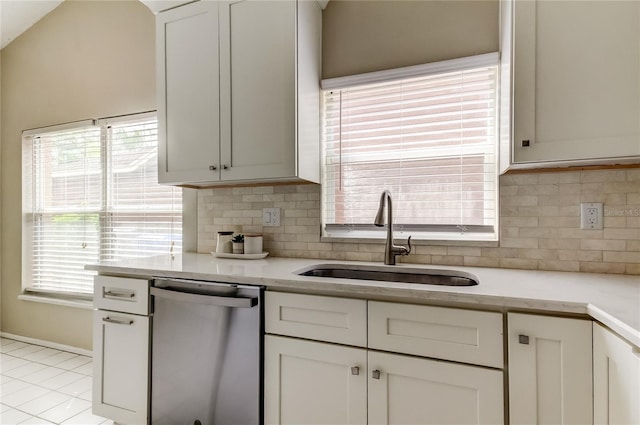 11641 Branch Mooring Dr, Tampa, FL 33635 - kitchen featuring stainless steel dishwasher, a sink, decorative backsplash, and light tile patterned flooring