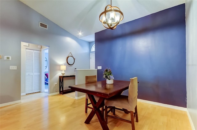 11641 Branch Mooring Dr, Tampa, FL 33635 - dining space featuring a chandelier, light wood-style floors, baseboards, and high vaulted ceiling