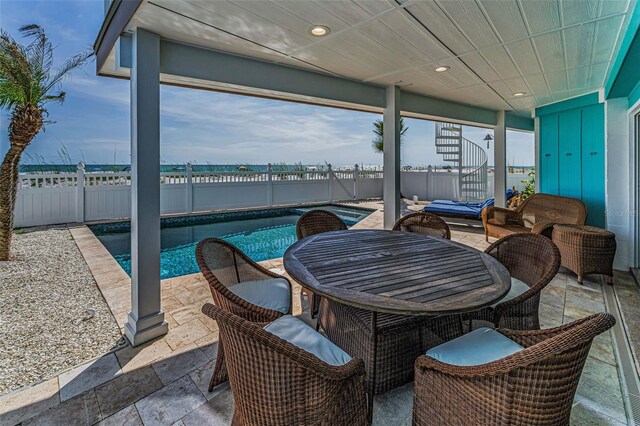 13303 Gulf Ln, Madeira Beach, FL 33708 - fenced backyard with a patio area and outdoor dining space