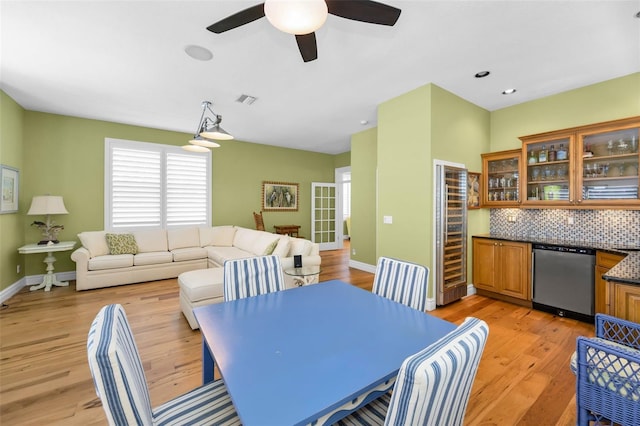 13303 Gulf Ln, Madeira Beach, FL 33708 - dining room featuring wine cooler, light wood finished floors, baseboards, and ceiling fan