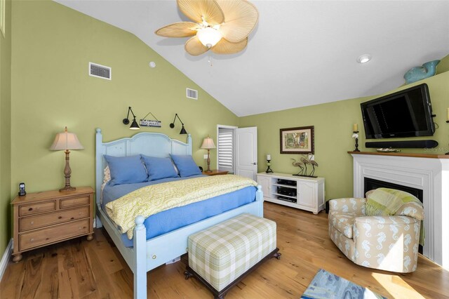 13303 Gulf Ln, Madeira Beach, FL 33708 - bedroom featuring vaulted ceiling, wood finished floors, a fireplace, ceiling fan, and recessed lighting