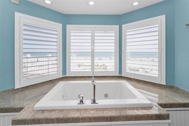 13303 Gulf Ln, Madeira Beach, FL 33708 - bathroom featuring a tub with jets and recessed lighting