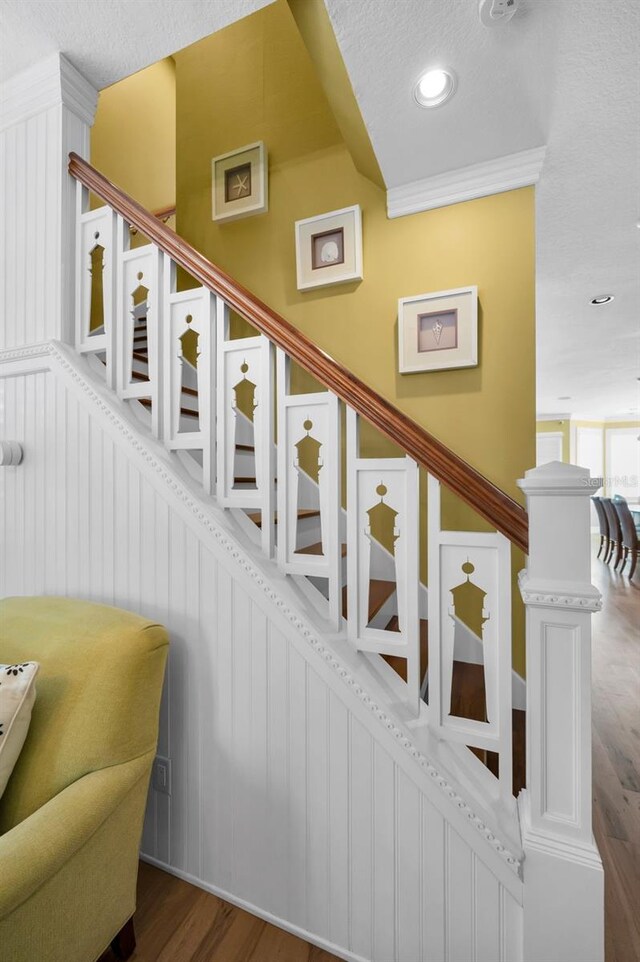 13303 Gulf Ln, Madeira Beach, FL 33708 - stairway featuring wood finished floors, recessed lighting, and a textured ceiling