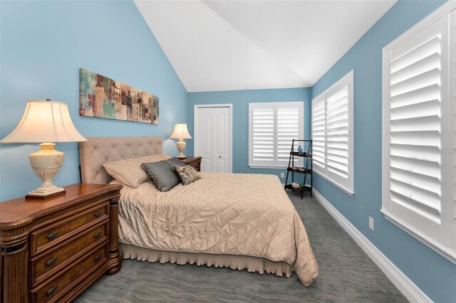 13303 Gulf Ln, Madeira Beach, FL 33708 - bedroom with carpet flooring, lofted ceiling, a closet, and baseboards