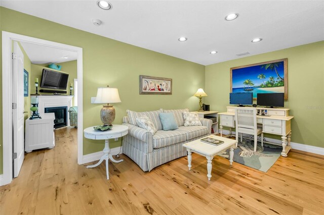 13303 Gulf Ln, Madeira Beach, FL 33708 - living area with baseboards, wood finished floors, recessed lighting, and a glass covered fireplace