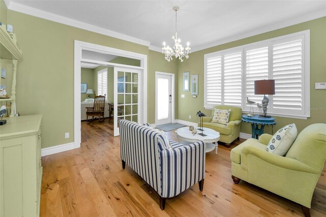 13303 Gulf Ln, Madeira Beach, FL 33708 - living area featuring a chandelier, light wood finished floors, crown molding, and baseboards