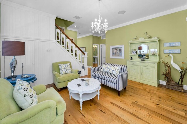 13303 Gulf Ln, Madeira Beach, FL 33708 - living area featuring light wood-type flooring, stairs, a chandelier, crown molding, and baseboards