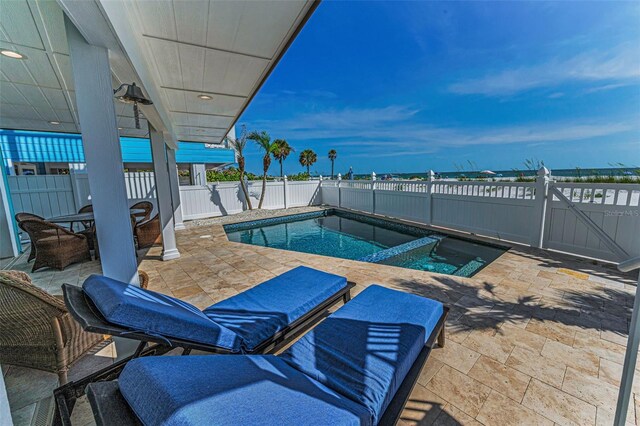 13303 Gulf Ln, Madeira Beach, FL 33708 - view of pool featuring a patio area, a fenced backyard, and a pool with connected hot tub