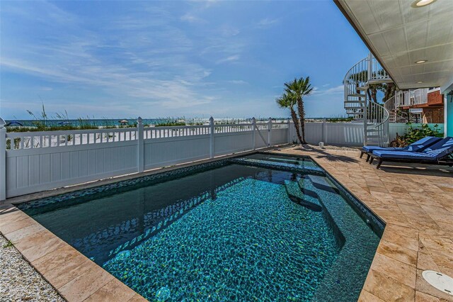 13303 Gulf Ln, Madeira Beach, FL 33708 - view of swimming pool with a fenced backyard, a pool with connected hot tub, a patio, and stairway
